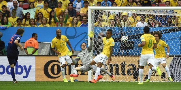 Netherlands' defender Daley Blind (L) scores during the third place play-off football match between Brazil and Netherlands during the 2014 FIFA World Cup at the National Stadium in Brasilia on July 12, 2014. AFP PHOTO / ODD ANDERSEN (Photo credit should read ODD ANDERSEN/AFP/Getty Images)