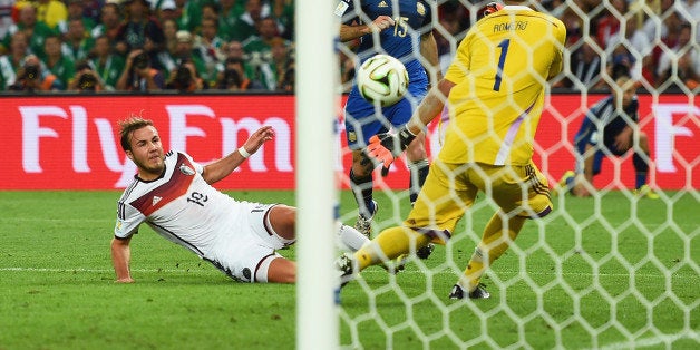 RIO DE JANEIRO, BRAZIL - JULY 13: Mario Goetze of Germany scores his team's first goal past Sergio Romero of Argentina in extra time during the 2014 FIFA World Cup Brazil Final match between Germany and Argentina at Maracana on July 13, 2014 in Rio de Janeiro, Brazil. (Photo by Laurence Griffiths/Getty Images)