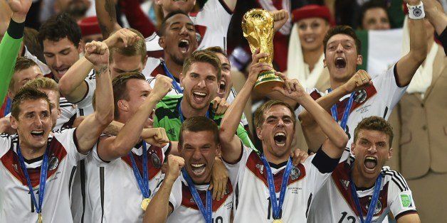 Germany's defender and captain Philipp Lahm (front-R) holds up the World Cup trophy as he celebrates on with his teammates after winning the 2014 FIFA World Cup final football match between Germany and Argentina 1-0 following extra-time at the Maracana Stadium in Rio de Janeiro, Brazil, on July 13, 2014. AFP PHOTO / FABRICE COFFRINI (Photo credit should read FABRICE COFFRINI/AFP/Getty Images)