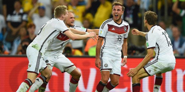 RIO DE JANEIRO, BRAZIL - JULY 13: Mario Goetze of Germany (2nd R) celebrates scoring his team's first goal in extra time with teammates Andre Schuerrle, Benedikt Hoewedes and Thomas Mueller during the 2014 FIFA World Cup Brazil Final match between Germany and Argentina at Maracana on July 13, 2014 in Rio de Janeiro, Brazil. (Photo by Laurence Griffiths/Getty Images)