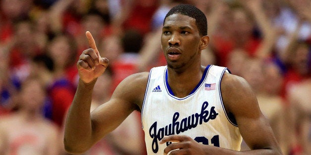 LAWRENCE, KS - JANUARY 18: Joel Embiid #21 of the Kansas Jayhawks reacts after scoring during the game against the Oklahoma State Cowboys at Allen Fieldhouse on January 18, 2014 in Lawrence, Kansas. (Photo by Jamie Squire/Getty Images)