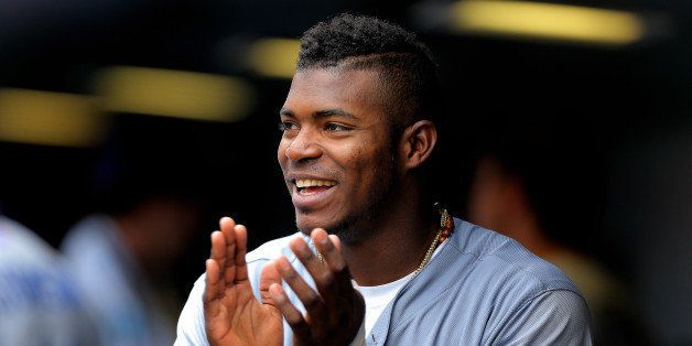 DENVER, CO - JULY 6: Yasiel Puig #66 of the Los Angeles Dodgers cheers in the dugout after his team scored during the fifth inning against the Colorado Rockies at Coors Field on July 6, 2014 in Denver, Colorado. (Photo by Justin Edmonds/Getty Images)