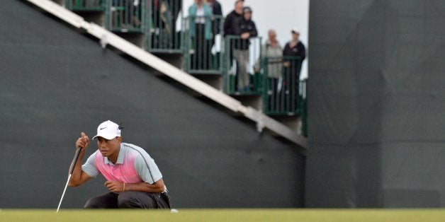 US golfer Tiger Woods lines up a putt on the 5th green during his third round, on day three of the 2014 British Open Golf Championship at Royal Liverpool Golf Course in Hoylake, north west England on July 19, 2014. AFP PHOTO / PAUL ELLIS (Photo credit should read PAUL ELLIS/AFP/Getty Images)