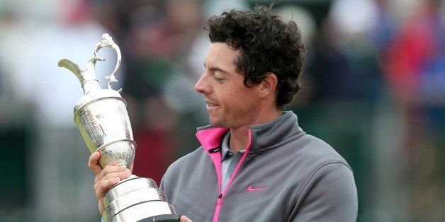 Northern Ireland's Rory McIlroy studies the Claret Jug after winning the 2014 British Open Golf Championship at Royal Liverpool Golf Course in Hoylake, north west England on July 20, 2014. McIlroy won the British Open at Royal Liverpool Golf Course in Hoylake with a final round of 71. The 25-year-old Northern Irishman won with a seventeen under par total of 271, two strokes clear of Rickie Fowler and Sergio Garcia. Rory McIlroy joined the elite list of golfers to have won three of the four major titles at Hoylake on Sunday. At 25, McIlroy joined legends Tiger Woods and Jack Nicklaus as the only players to have achieved that feat by the time they were 25 and he is the first European to have won three majors. AFP PHOTO / ANDREW YATES (Photo credit should read ANDREW YATES/AFP/Getty Images)