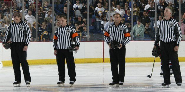 BUFFALO, NY - SEPTEMBER 21: (L-R) Officials David Brisebois, Chris Ciamaga, Paul Devorski and Brad Kovachik stand for the National Anthem before the Buffalo Sabres game against the Columbus Blue Jackets on September 21, 2007 at HSBC Arena in Buffalo, New York. (Photo by Rick Stewart/Getty Images)