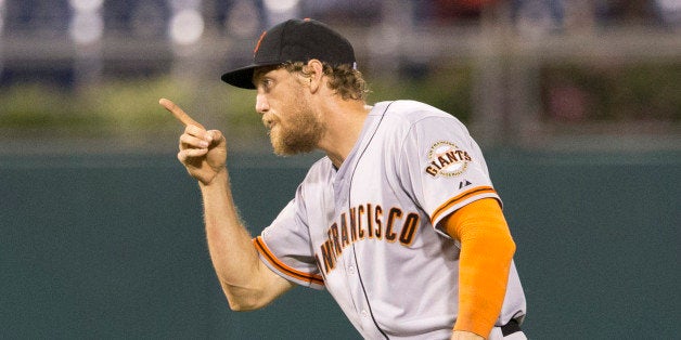 PHILADELPHIA, PA - JULY 23: Shortstop Brandon Crawford #35 and right fielder Hunter Pence #6 of the San Francisco Giants reac