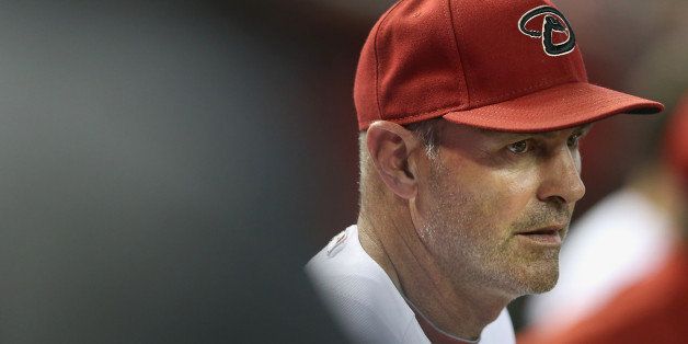 PHOENIX, AZ - AUGUST 05: Manager Kirk Gibson #23 of the Arizona Diamondbacks watches from the dugout during the MLB game against the Kansas City Royals at Chase Field on August 5, 2014 in Phoenix, Arizona. (Photo by Christian Petersen/Getty Images)