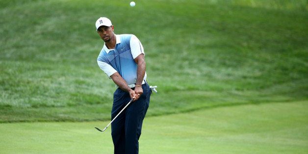 LOUISVILLE, KY - AUGUST 06: Tiger Woods of the United States chips to a green during a practice round prior to the start of the 96th PGA Championship at Valhalla Golf Club on August 6, 2014 in Louisville, Kentucky. (Photo by Andy Lyons/Getty Images)
