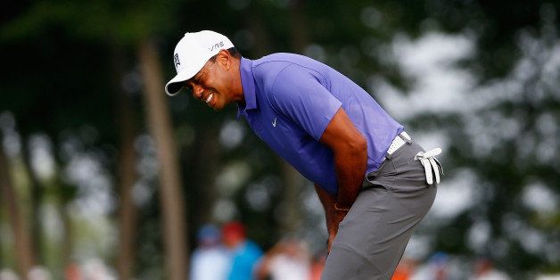 LOUISVILLE, KY - AUGUST 07: Tiger Woods of the United States reacts to a missed putt on the tenth green during the first round of the 96th PGA Championship at Valhalla Golf Club on August 7, 2014 in Louisville, Kentucky. (Photo by Sam Greenwood/Getty Images)