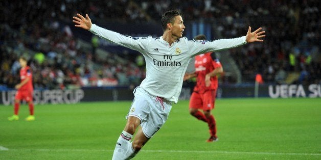 Real Madrid's Portuguese striker Cristiano Ronaldo celebrates scoring his second goal during the UEFA Super Cup football match between Real Madrid and Sevilla at Cardiff City Stadium in Cardiff, south Wales on August 12, 2014. AFP PHOTO / GLYN KIRK (Photo credit should read GLYN KIRK/AFP/Getty Images)