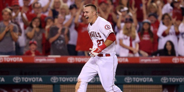 ANAHEIM, CA - JULY 04: Mike Trout #27 of the Los Angeles Angels of Anaheim celebrates as he runs home after hitting a game w