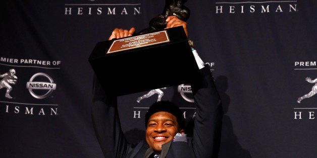 NEW YORK, NY - DECEMBER 14: Jameis Winston, quarterback of the Florida State Seminoles, hoist the trophy during a press conference after the 2013 Heisman Trophy Presentation at the Marriott Marquis on December 14, 2013 in New York City. (Photo by Jeff Zelevansky/Getty Images)