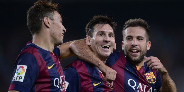 Barcelona's Argentinian forward Lionel Messi (C) is congratulated by teammate Barcelona's defender Jordi Alba (R) and Barcelona's forward Munir after scoring during the Spanish league football match FC Barcelona vs Elche CF at the Camp Nou stadium in Barcelona on August 24, 2014. AFP PHOTO/ JOSEP LAGO (Photo credit should read JOSEP LAGO/AFP/Getty Images)