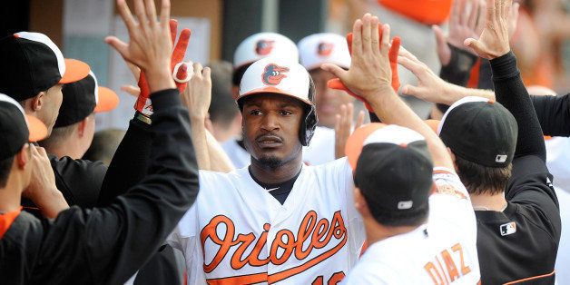 BALTIMORE, MD - JULY 30: Adam Jones #10 of the Baltimore Orioles celebrates with teammates after hitting a home run against the Los Angeles Angels at Oriole Park at Camden Yards on July 30, 2014 in Baltimore, Maryland. (Photo by G Fiume/Getty Images)