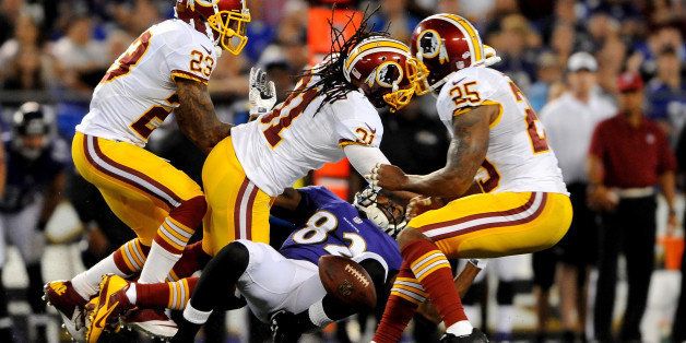 BALTIMORE, MD - AUGUST 23: Strong safety Brandon Meriweather #31 of the Washington Redskins defends wide receiver Torrey Smith #82 of the Baltimore Ravens during a preseason game at M&T Bank Stadium on August 23, 2014 in Baltimore, Maryland. (Photo by Larry French/Getty Images)
