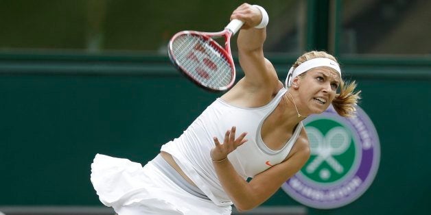 Sabine Lisicki of Germany serves to Agnieszka Radwanska of Poland during their Women's singles semifinal match at the All England Lawn Tennis Championships in Wimbledon, London, Thursday, July 4, 2013. (AP Photo/Anja Niedringhaus)