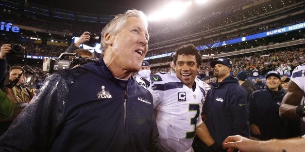 Seattle Seahawks head coach Pete Carroll and quarterback Russell Wilson celebrate after a 43-8 victory against the Denver Broncos in Super Bowl XLVIII at MetLife Stadium in East Rutherford, N.J., on Sunday, Feb. 2, 2014. (Tony Overman/The Olympian/MCT via Getty Images)