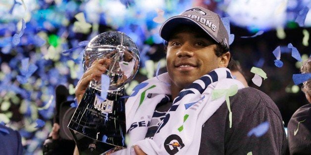 Seattle Seahawks' quarterback Russell Wilson holds the Lombardi Trophy after the NFL Super Bowl XLVIII football game Sunday,