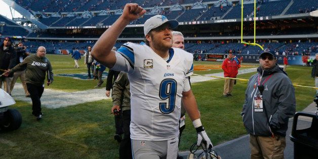 Detroit Lions quarterback Matthew Stafford (9) celebrates as he walks off the field after the Lions' 21-19 win over the Chicago Bears in an NFL football game Sunday, Nov. 10, 2013, in Chicago. (AP Photo/Charles Rex Arbogast)