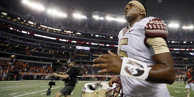 Florida State quarterback Jameis Winston runs off the field after a 37-31 win against Oklahoma State at AT&T Stadium in Arlington, Texas, on Saturday, Aug. 30, 2014. (Brandon Wade/Fort Worth Star-Telegram/MCT via Getty Images)