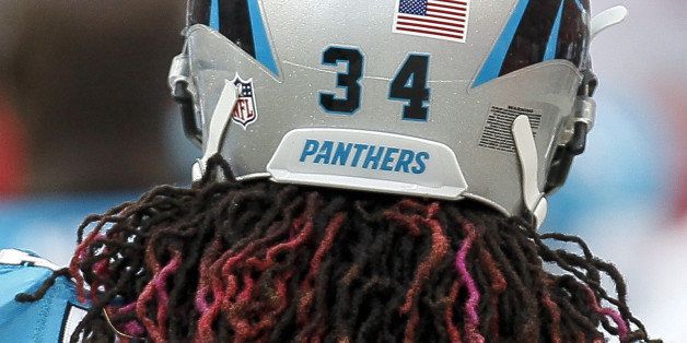 TAMPA, FL - SEPTEMBER 7: A rearview of Runningback DeAngelo Williams #34 of the Carolina Panthers hair through his helmet during the game against the Tampa Bay Buccaneers at Raymond James Stadium on September 7, 2014 in Tampa, Florida. Wiliams dying his dreadlocks pink in honor of his mom, Sandra Hill, who died from breast cancer in May at age 53. Carolina defeated Tampa Bay 20-14. (Photo by Don Juan Moore/Getty Images)