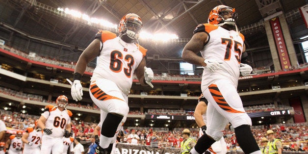 GLENDALE, AZ - AUGUST 24: Defensive tackle Larry Black #63 and defensive tackle Devon Still #75 of the Cincinnati Bengals run out onto the field for the preseason NFL game against the Arizona Cardinals at the University of Phoenix Stadium on August 24, 2014 in Glendale, Arizona. The Bengals defeated the Cardinals 19-13. (Photo by Christian Petersen/Getty Images) 