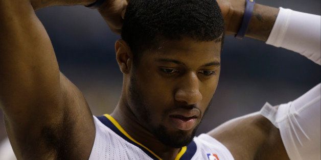 Indiana Pacers forward Paul George (24) reacts during the first half in Game 5 of an opening-round NBA basketball playoff series against the Atlanta Hawks Monday, April 28, 2014, in Indianapolis. (AP Photo/Darron Cummings)