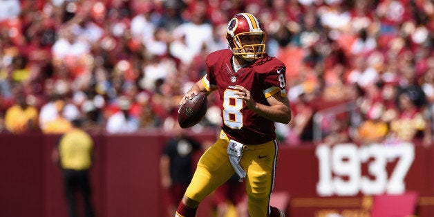 LANDOVER, MD - SEPTEMBER 14: Quarterback Kirk Cousins #8 of the Washington Redskins rolls out during a game against the Jacksonville Jaguars at FedExField on September 14, 2014 in Landover, Maryland. (Photo by Patrick Smith/Getty Images)