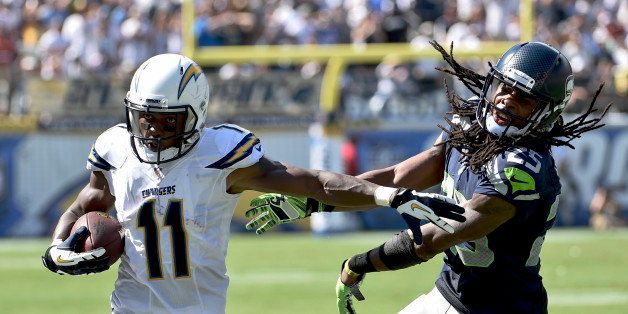San Diego Chargers wide receiver Eddie Royal, left, pushes off Seattle Seahawks cornerback Richard Sherman during the second half of an NFL football game on Sunday, Sept. 14, 2014, in San Diego. (AP Photo/Denis Poroy)