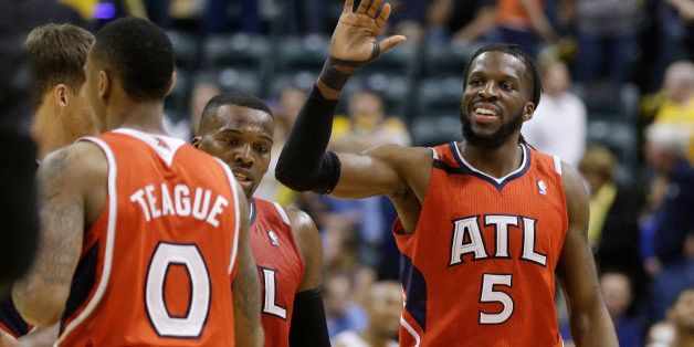 Atlanta Hawks' DeMarre Carroll (5) celebrates with his teammates late in the second half in Game 5 of an opening-round NBA basketball playoff series against the Indiana Pacers Monday, April 28, 2014, in Indianapolis. Atlanta defeated Indiana 107-97. (AP Photo/Darron Cummings)