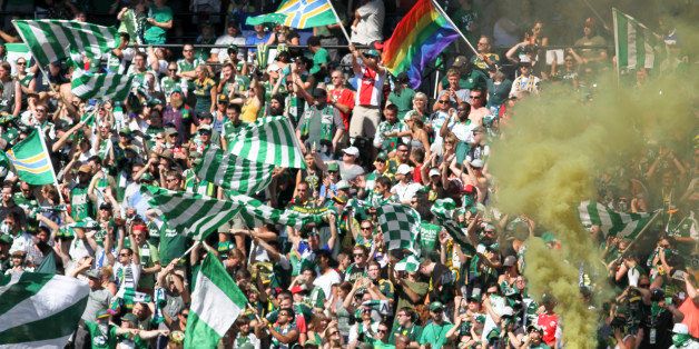 Portland Timbers fans, go wild as the their team score a goal at a game against the Seattle Sounders during an an MLS soccer match in Portland, Ore., Sunday, Aug. 24, 2014. The Sounders won the game 4 to 1. (AP Photo/Natalie Behring)