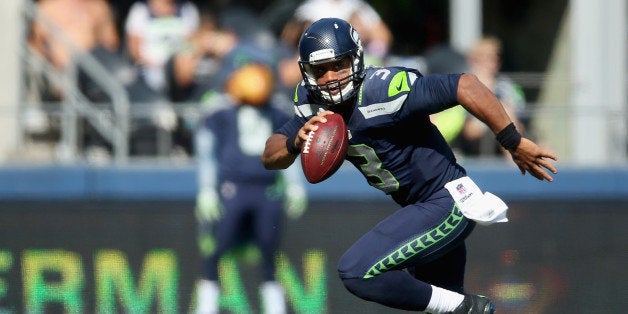 SEATTLE, WA - SEPTEMBER 21: Quarterback Russell Wilson #3 of the Seattle Seahawks scrambles against the Denver Broncos at Ce