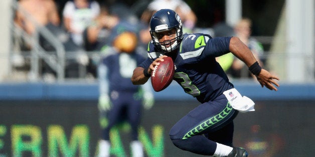 SEATTLE, WA - SEPTEMBER 21: Quarterback Russell Wilson #3 of the Seattle Seahawks scrambles against the Denver Broncos at CenturyLink Field on September 21, 2014 in Seattle, Washington. (Photo by Jeff Gross/Getty Images) 