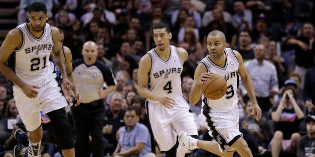 San Antonio Spurs' Tony Parker (9), of France, is followed by teammates Tim Duncan (21) and Danny Green (4) as he brings the ball up court against the Oklahoma City Thunder during the first half of Game 2 of a Western Conference finals NBA basketball playoff series, Wednesday, May 21, 2014, in San Antonio. (AP Photo/Eric Gay)