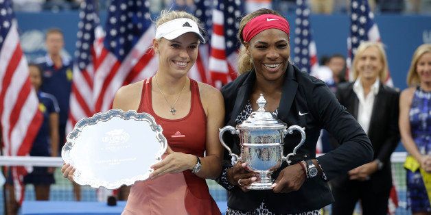 Caroline Wozniacki, of Denmark, left, and Serena Williams, of the United States, pose for photos after Williams defeated Wozniacki in the championship match of the 2014 U.S. Open tennis tournament, Sunday, Sept. 7, 2014, in New York. (AP Photo/Darron Cummings)