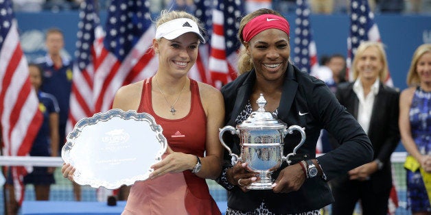 Caroline Wozniacki, of Denmark, left, and Serena Williams, of the United States, pose for photos after Williams defeated Wozn