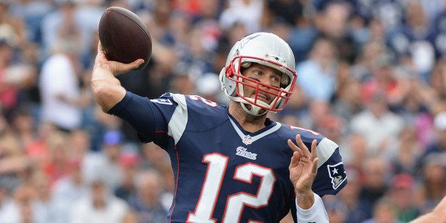 FOXBORO, MA - SEPTEMBER 21: Tom Brady #12 of the New England Patriots throws the ball in the first quarter during a game against the Oakland Raiders at Gillette Stadium on September 21, 2014 in Foxboro, Massachusetts. (Photo by Darren McCollester/Getty Images)