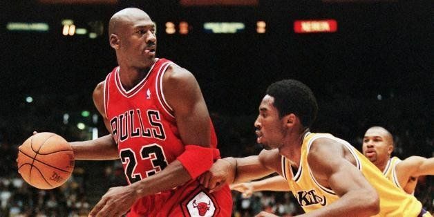 LOS ANGELES, UNITED STATES: Michael Jordan of the Chicago Bulls (L) eyes the basket as he is guarded by Kobe Bryant of the Los Angeles Lakers during their 01 February game in Los Angeles, CA. Jordan will appear in his 12th NBA All-Star game 08 February while Bryant will make his first All-Star appearance. The Lakers won the game 112-87. AFP PHOTO/Vince BUCCI (Photo credit should read Vince Bucci/AFP/Getty Images)
