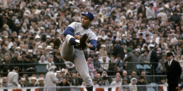 MINNEAPOLIS, MN - OCTOBER 14: Picher Sandy Koufax of the Los Angeles Dodgers winds up to throw a pitch against the Minnesota Twin in game 7 of the 1965 World Series, October 14, 1965 at Metropolitan Stadium in Minneapolis, Minnesota. The Dodgers won the series 4 games to 3. Koufax was the series MVP and played for the Dodgers from 1955-66. (Photo by Focus on Sport/Getty Images)