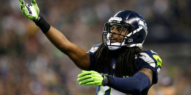 Seattle Seahawks cornerback Richard Sherman gestures to the crowd in the second half of an NFL football game against the Green Bay Packers, Thursday, Sept. 4, 2014, in Seattle. The Seahawks won 36-16. (AP Photo/Scott Eklund)