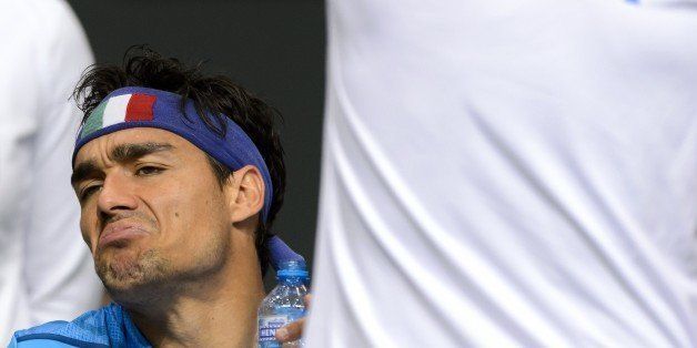 Italy's Fabio Fognini reacts during a break in his match against Switzerland's Stanislas Wawrinka during the second tennis match of the Davis Cup semi-final between Switzerland and Italy, on September 12, 2014 in Geneva. AFP PHOTO / FABRICE COFFRINI (Photo credit should read FABRICE COFFRINI/AFP/Getty Images)