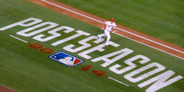 ANAHEIM, CA - OCTOBER 2: Mike Trout #27 of the Los Angeles Angels of Anaheim runs past the Postseason signage painted on the field during the game against the Kansas City Royals during Game One of the American League Division Series on October 2, 2014 at Angel Stadium of Anaheim in Anaheim, California. (Photo by Matt Brown/Angels Baseball LP/Getty Images)