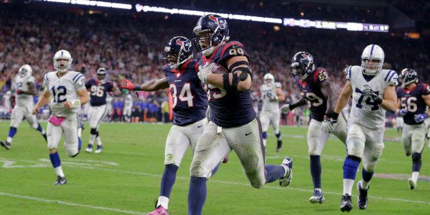 Houston Texans' J.J. Watt (99) returns a fumble against Indianapolis Colts for a 45-yard touchdown during the second half of an NFL football game, Thursday, Oct. 9, 2014, in Houston. (AP Photo/Patric Schneider)