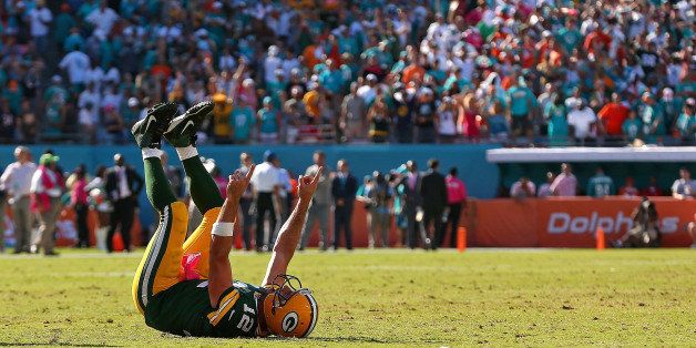 MIAMI GARDENS, FL - OCTOBER 12: Aaron Rodgers #12 of the Green Bay Packers celebrates the winning touchdown during a game against the Miami Dolphins at Sun Life Stadium on October 12, 2014 in Miami Gardens, Florida. (Photo by Mike Ehrmann/Getty Images)
