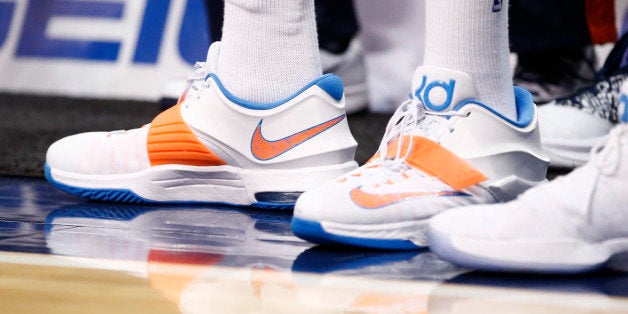 Oklahoma City Thunder forward Kevin Durant stands on the sideline during the second half of a preseason NBA basketball game against the Dallas Mavericks, Friday, Oct. 10, 2014, in Dallas, Texas. (AP Photo/Jim Cowsert)