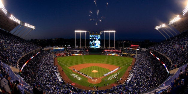 KANSAS CITY, MO - OCTOBER 14: Fireworks explode overhead as the Baltimore Orioles and the Kansas City Royals stand on the baseline during the national anthem prior to Game Three of the American League Championship Series at Kauffman Stadium on October 14, 2014 in Kansas City, Missouri. (Photo by Jamie Squire/Getty Images)