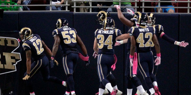 St. Louis Rams' Stedman Bailey, left, is congratulated by teammates after running a punt back 90 yards for a touchdown during the second quarter of an NFL football game against the Seattle Seahawks, Sunday, Oct. 19, 2014, in St. Louis. (AP Photo/Tom Gannam)