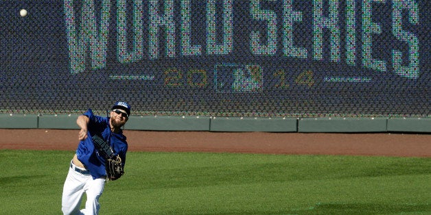 Kansas City Royals' Alex Gordon throws during baseball practice Monday, Oct. 20, 2014, in Kansas City, Mo. The Royals will host the San Francisco Giants in Game 1 of the World Series on Oct. 21. (AP Photo/Charlie Riedel)