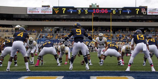 MORGANTOWN, WV - OCTOBER 18: Clint Trickett #9 of the West Virginia Mountaineers directs the offense in the first half against the Baylor Bears during the game on October 18, 2014 at Mountaineer Field in Morgantown, West Virginia. (Photo by Justin K. Aller/Getty Images)