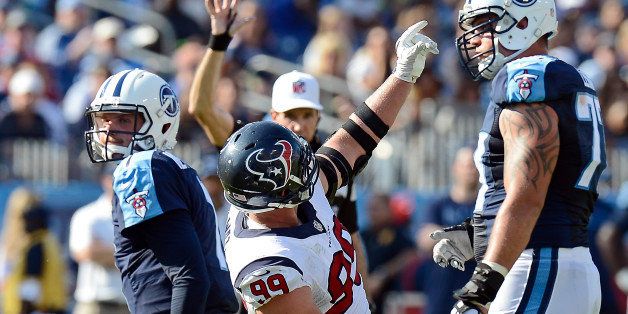 Tennessee Titans quarterback Zach Mettenberger, left, gets up as Houston Texans defensive end J.J. Watt (99) celebrates after Watt sacked Mettenberger for a 4-yard loss in the fourth quarter of an NFL football game Sunday, Oct. 26, 2014, in Nashville, Tenn. (AP Photo/Mark Zaleski)